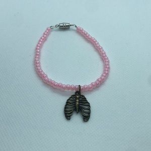 pink beaded bracelet with bronze rib cage charm (handmade)